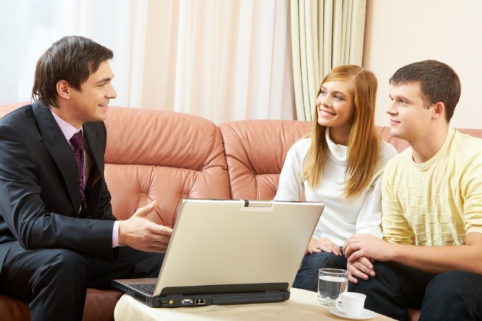 Portrait of a businessman interacting with young couple
